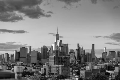 View of cityscape against cloudy sky