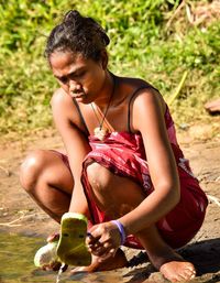 Young woman sitting on field