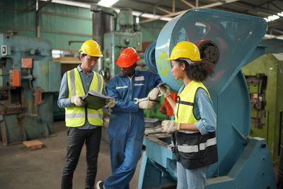 Portrait of male worker standing in the heavy industry manufacturing factory.