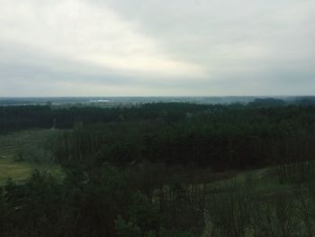 Scenic view of field against cloudy sky