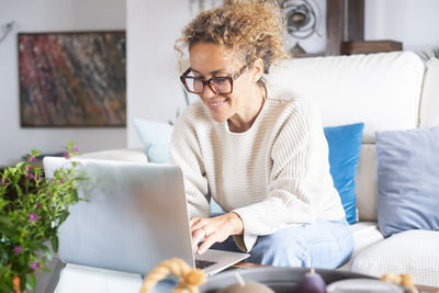 Young woman using laptop at home