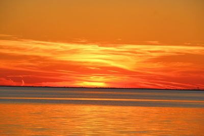 Scenic view of sea against orange sky