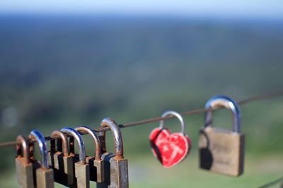 Close-up of padlocks hanging on railing