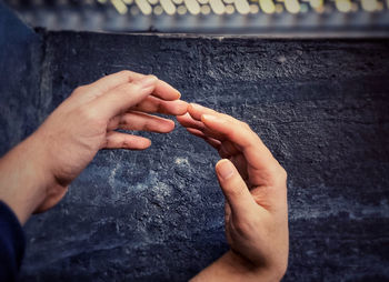 Close-up of man hand on rock