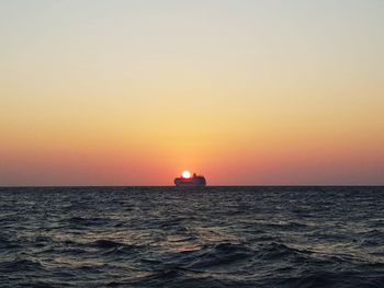 Scenic view of sea against orange sky