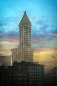 Low angle view of modern buildings against sky during sunset