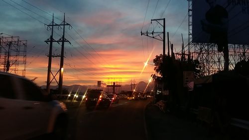 Cars on road at sunset