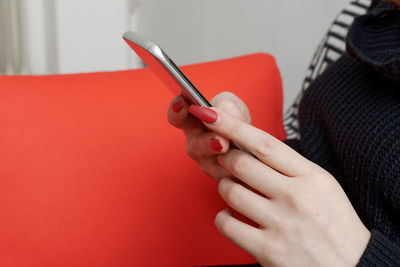 Close-up of woman hand holding red table