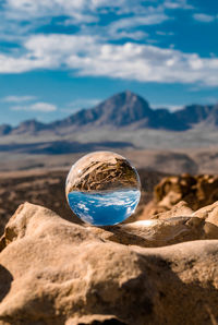 Close-up of rock on mountain against sky