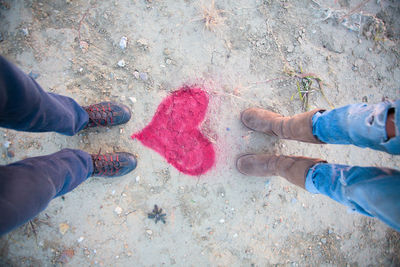 Low section of friends standing on heart