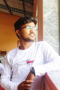 Portrait of young man drinking glasses