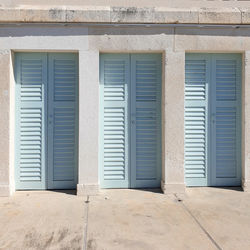 Blue shutter doors located at bonj les bains beach hvar, croatia