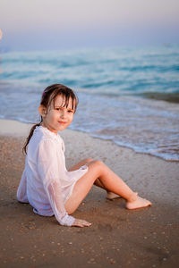 Young woman sitting on beach