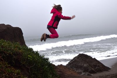 Woman jumping on beach