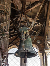 Low angle view of old electric lamp hanging from ceiling