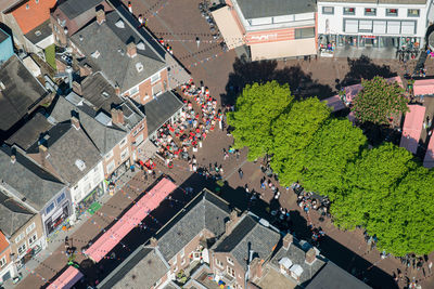 High angle view of vehicles on road along buildings