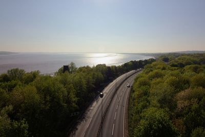 High angle view of road by sea against sky