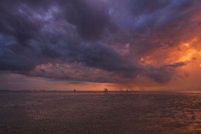 Scenic view of beach against sky during sunset