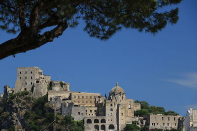 Low angle view of buildings against blue sky