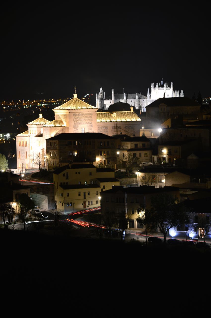 HIGH ANGLE VIEW OF BUILDINGS AGAINST SKY AT NIGHT