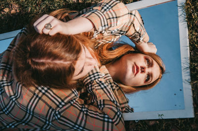 Young woman lying down outdoors