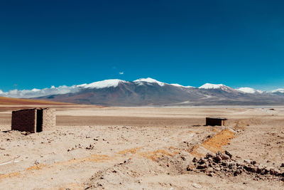 Scenic view of desert against blue sky