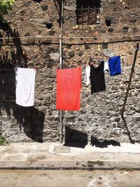 Clothes drying against wall in city