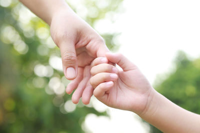 Children's hands with the warmth of mother's care