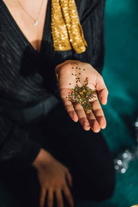 Hand holding gold glitter close up