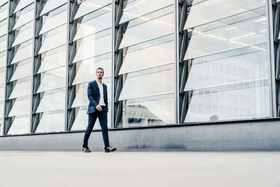 Germany, berlin, businessman walking at potsdamer platz