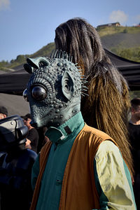 Rear view of people in traditional clothing against sky