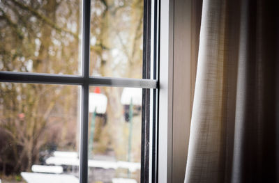 Curtain by glass window at home