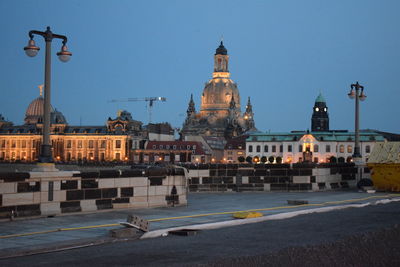 Buildings in city against clear sky