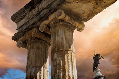 Low angle view of statue against cloudy sky