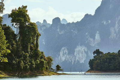 Scenic view of sea and mountains against sky