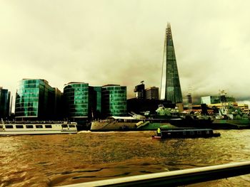 View of skyscrapers against cloudy sky