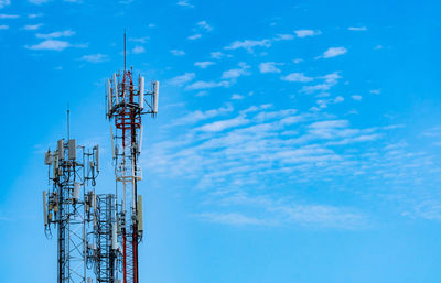 Telecommunication tower with blue sky and white clouds background. antenna on blue sky. 