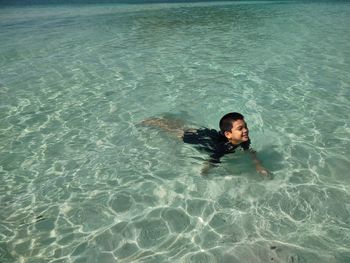 High angle view of woman swimming in sea