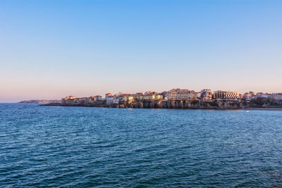 Scenic view of sea against clear blue sky