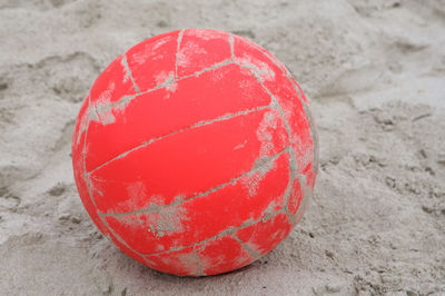 Close-up of red ball on sand