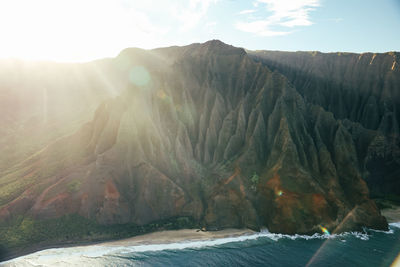 Wide view from helicopter of the na pali coast with morning sunlight on kauai, hawaii.