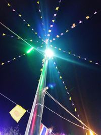 Low angle view of illuminated lights at night