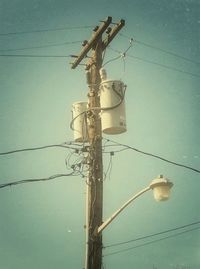 Low angle view of power lines against sky