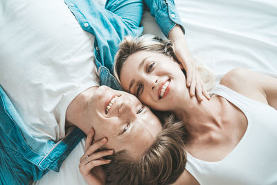 High angle view of woman lying on bed