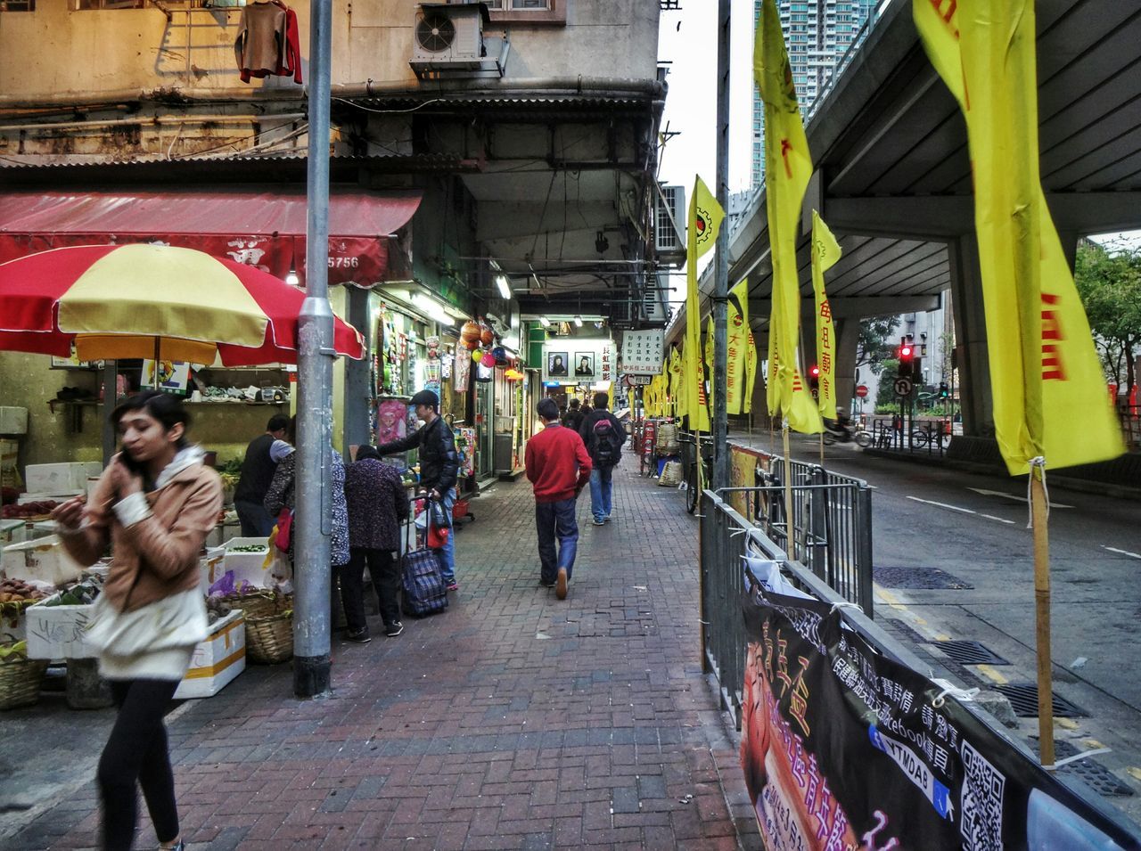 men, lifestyles, building exterior, street, walking, person, architecture, built structure, city, transportation, city life, market, retail, store, market stall, leisure activity, full length, casual clothing, rear view