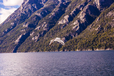 Scenic view of sea and mountains against sky