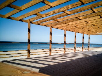 Pier on sea against clear sky