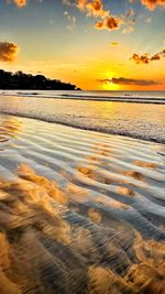 Scenic view of beach against sky during sunset