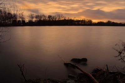 Scenic view of lake against sky during sunset