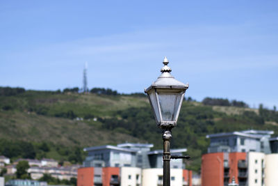 Close-up of street light against buildings in city